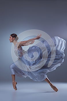 The beautiful ballerina dancing in blue long dress