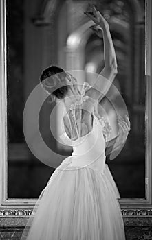 Beautiful ballerina dancing in front of the mirror