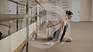 Beautiful ballerina doing gymnastic exercises