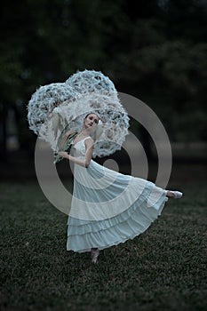 Beautiful ballerina with giant dandelions flowers