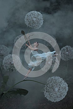 Beautiful ballerina with giant dandelions flowers
