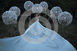 Beautiful ballerina with giant dandelions flowers