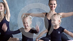Beautiful ballerinas in black tutus at a ballet lesson. Lovely girls dance at ballet school. Teachers show how to dance