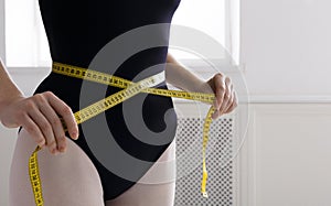 Beautiful ballerine torso with measuring tape, slim waist after diet