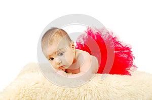 A beautiful ballet baby laying on a fur rug