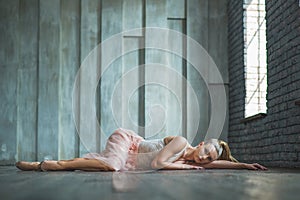 Beautiful ballet dancer lying on floor