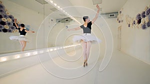 Beautiful ballet studio with a lady dancer executing spinning movements