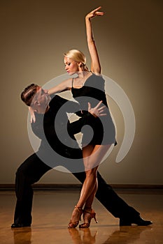 Beautiful ballroom couple preforming their pasonate exhibition d