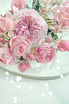 beautiful banner with a delicate bouquet of pink peony roses and bokeh hearts. Copy space