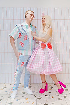 Beautiful barbie girl in white wig and pink dress and boyfriend ken.