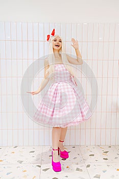 Beautiful barbie girl in white wig and pink dress. The image of a popular doll.