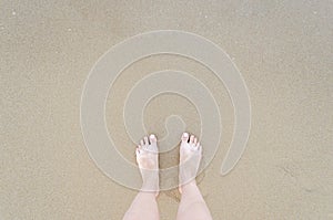 Beautiful bare feet on the beach