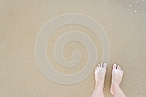 Beautiful bare feet on the beach