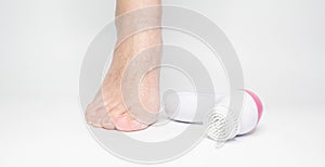 Beautiful barefoot female dry skin feet with a set of the pedicure tools