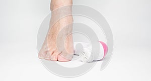 Beautiful barefoot female dry skin feet with a set of the pedicure tools