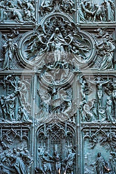 Beautiful bas-reliefs on the bronze door of  building of the Milan Cathedral Duomo di Milano, the cathedral church of Milan,