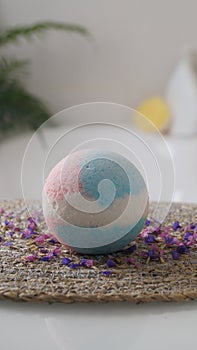 Beautiful bath bomb on wicker mat indoors