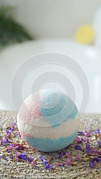 Beautiful bath bomb on wicker mat indoors