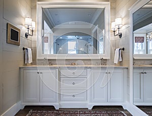 Beautiful bathroom interior with double sinks and marble counter, and large mirrors