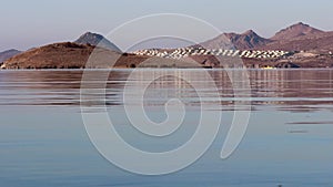 Beautiful bay with calm blue sea, boats, islands and mountains