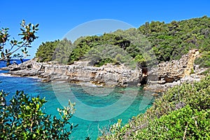 beautiful bay in croatia on the adriatic sea with stone cliffs and turquoise blue water