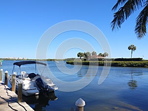 Beautiful bay front view with blue skies, water and boat