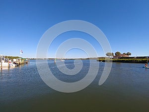 Beautiful bay front view with blue skies, water and boat