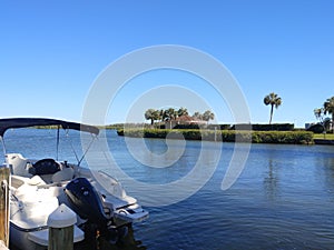 Beautiful bay front view with blue skies, water and boat