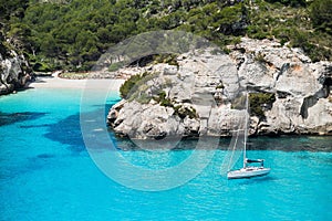 Beautiful bay in Mediterranean sea with sailing boat, Menorca island, Spain.