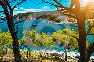 Beautiful bay with picturesque sea water surrounded by pine trees. Assos village Mediterranean Sea, Greece. Summer photo