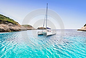 Beautiful bay with sailing boat catamaran, Corsica island, France