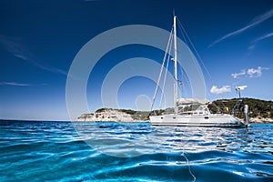Beautiful bay with sailing boat, Mediterranean sea. Yachting, travel and active lifestyle concept
