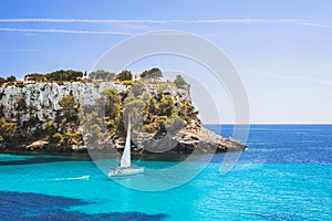 Beautiful bay with sailing boat yacht, Cala Galdana, Menorca island, Spain. Yachting, travel and active lifestyle concept photo