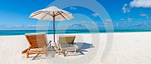Beautiful beach banner, two sun chairs and umbrella on tropical beach landscape. Summer vacation and holiday concept