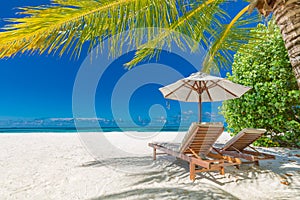 Beautiful beach banner, two sun chairs and umbrella on tropical beach landscape. Summer vacation and holiday concept