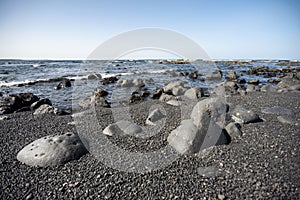 The beautiful beach of black and dark stones