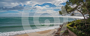 Beautiful beach at Costa Dorada in Miami Platja with a background of blue sky with clouds, Catalonia