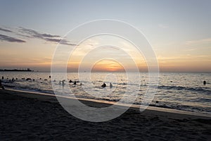 Beautiful beach dusk landscape with tourist silhouette