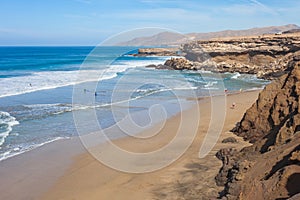 beautiful beach with rocky escarpments in the south west of the island of Fuerteventura photo