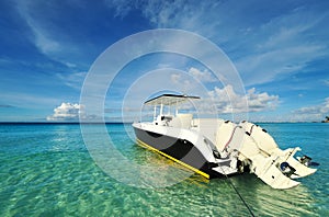 Beautiful beach with motor boat photo