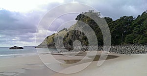 Beautiful beach with a nice promontory. Low Tide, cloudy sky, no People, untouched beach.