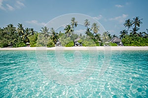 Beautiful beach with palm trees and moody sky. Summer vacation travel holiday background concept. Maldives paradise beach. Luxury