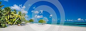 Beautiful beach panorama with palm trees and moody sky. Summer vacation travel holiday background concept. Maldives paradise beach