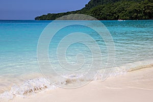 Beautiful beach with pristine turquoise water in Champagne Bay island of Papua new Guinea