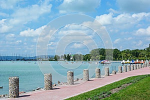 Beautiful beach with sailing boats and paddle boats at the Lake Balaton