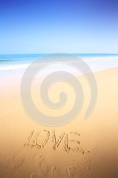 Beautiful beach with sand, blue waves and sky