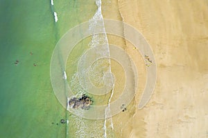 The beautiful beach, sea and group of surfers. Top view, drone photography