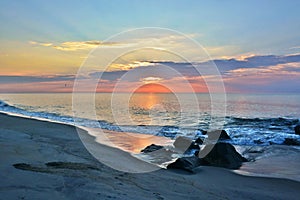 Beautiful Beach Sunrise Over Rock Jetty