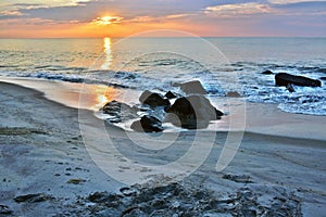 Beautiful Beach Sunrise Over Rock Jetty
