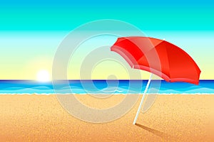 Beautiful beach. Sunset or dawn on the coast of the sea. A red umbrella stands in the sand. The sun sets over the ocean